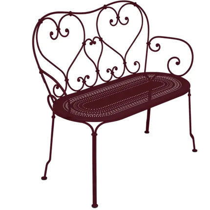 Decorative Fermob 1900 Bench with sleek metal design and curved legs, ideal for outdoor or patio seating.