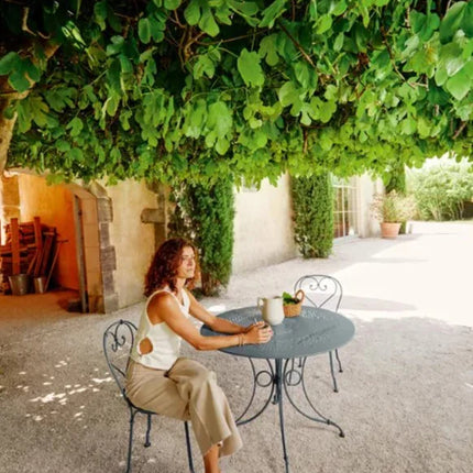 Fermob 1900 outdoor chair with metal frame and slatted design, suitable for patio or garden seating.