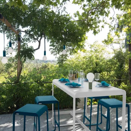 Fermob Bellevie high outdoor lounge table, 140x80 cm, with sleek design ideal for outdoor food service or hospitality settings.