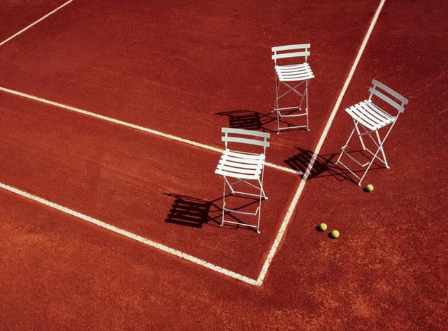 Fermob Bistro High Stool, foldable bar chair with metal frame and wooden seat, suitable for outdoor restaurant or hotel bar setting.