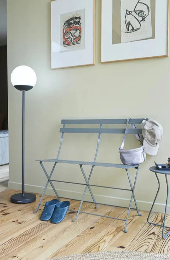 Fermob Bistro Two Seater Ottoman folding chair in black metal, designed for outdoor use and stylish home or hospitality spaces.