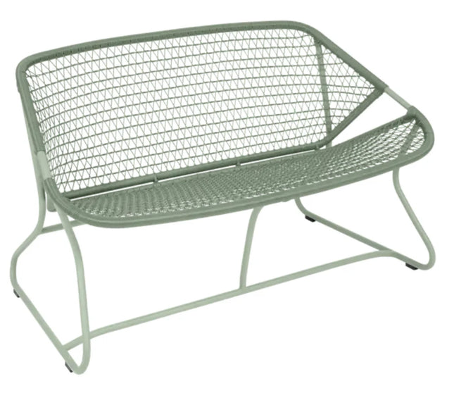 Fermob Sixties outdoor sofa with vibrant cactus green cushions and sleek metal frame, perfect for stylish outdoor seating.