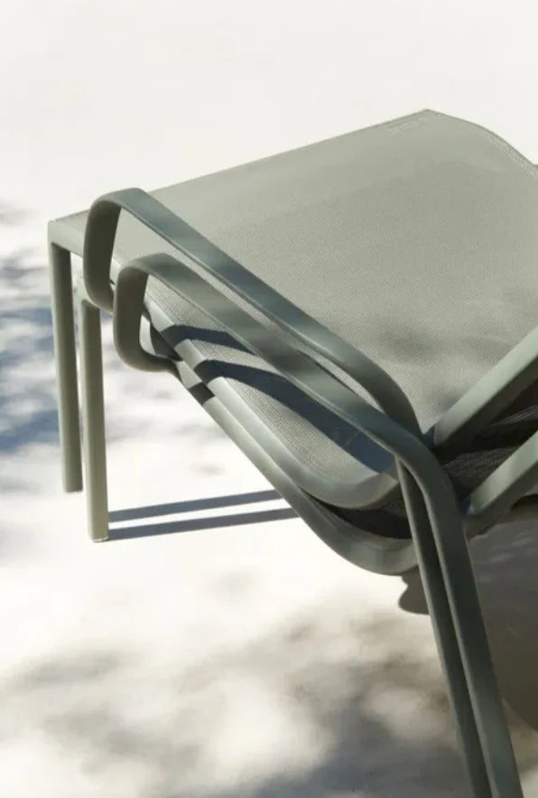 Fermob Cadiz Lounge Armchair with a sleek, modern design, featuring a comfortable seat and stackable feature for outdoor or indoor use.