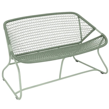 Fermob Sixties outdoor sofa in vibrant color with sleek, modern design and cushioned seating for outdoor lounging.