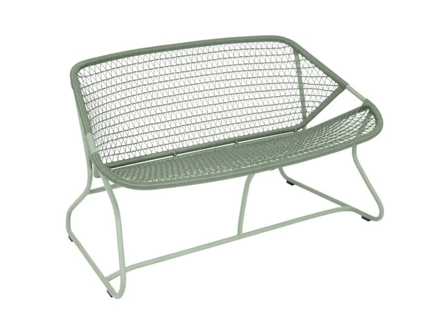 Fermob Sixties outdoor sofa in vibrant color with sleek, modern design and cushioned seating for outdoor lounging.