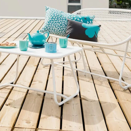 Fermob Sixties outdoor sofa with retro-inspired design, featuring plush cushions and metal frame for stylish outdoor seating.