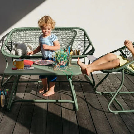 Outdoor Sixties Sofa by Fermob featuring colorful, vintage-inspired cushions and a sleek metal frame for stylish outdoor lounging.