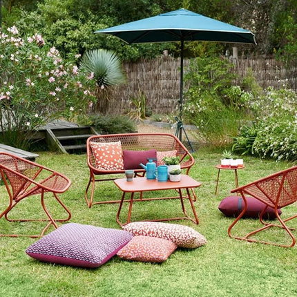 Fermob Sixties outdoor sofa with vibrant orange cushions and sleek modern design, perfect for stylish outdoor seating.