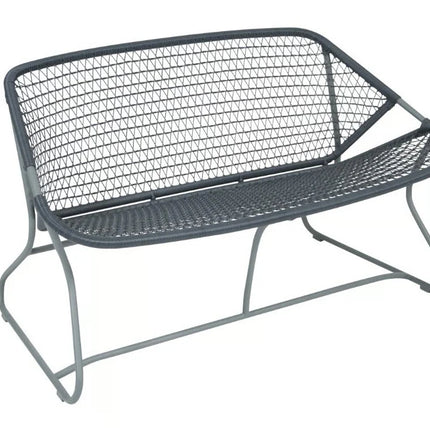 Fermob Sixties outdoor sofa with colorful cushions, stylish mid-century modern design, and metal frame for outdoor relaxation.